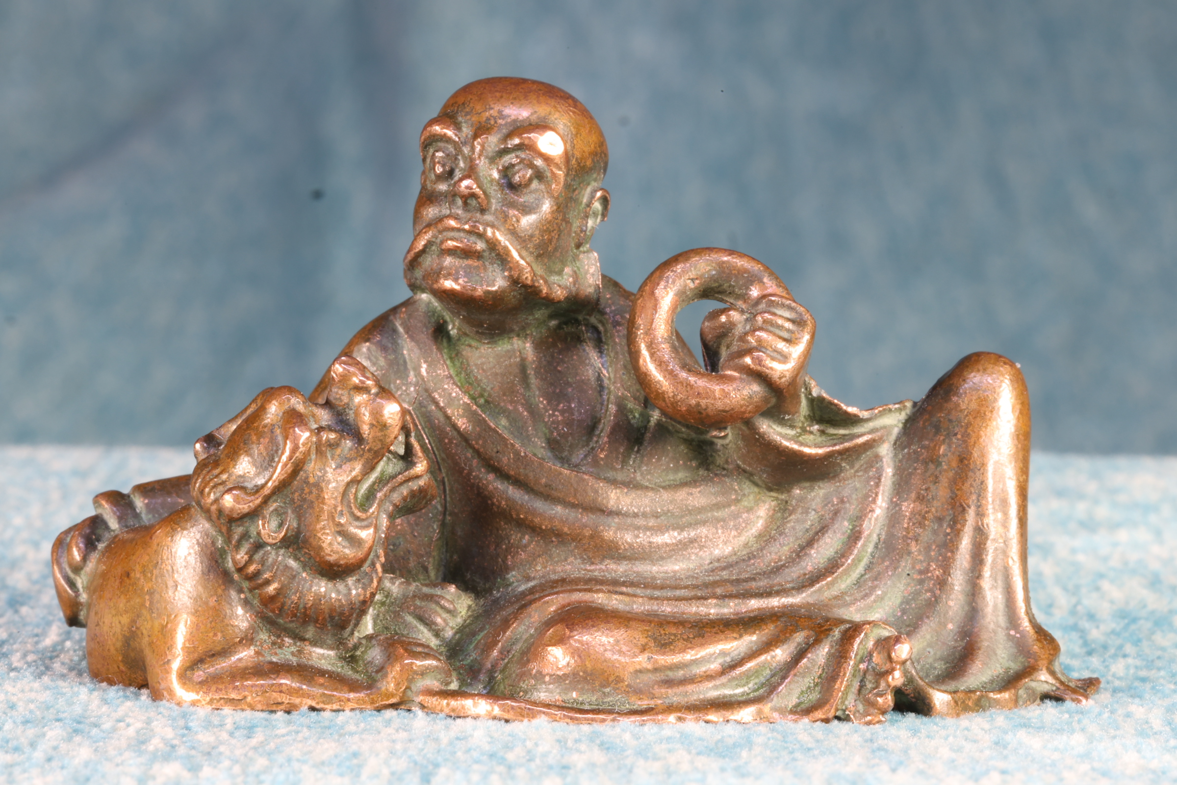 Antiguedades de miniature sculpture of an elderly chinese man with a hoop and a foo dog 18th century