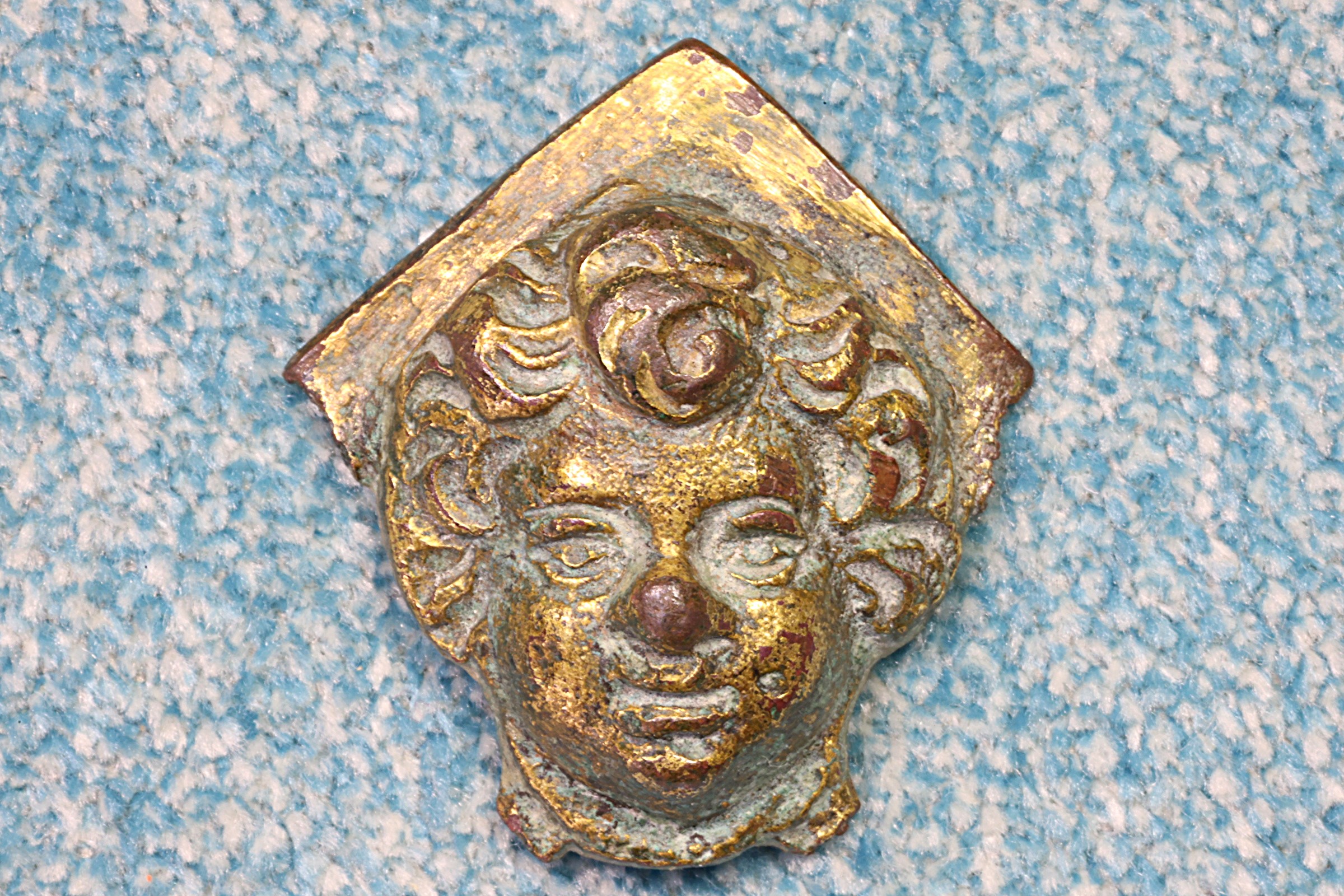 Antiguedades de brass miniature of a young mans face earlier than the 15th century