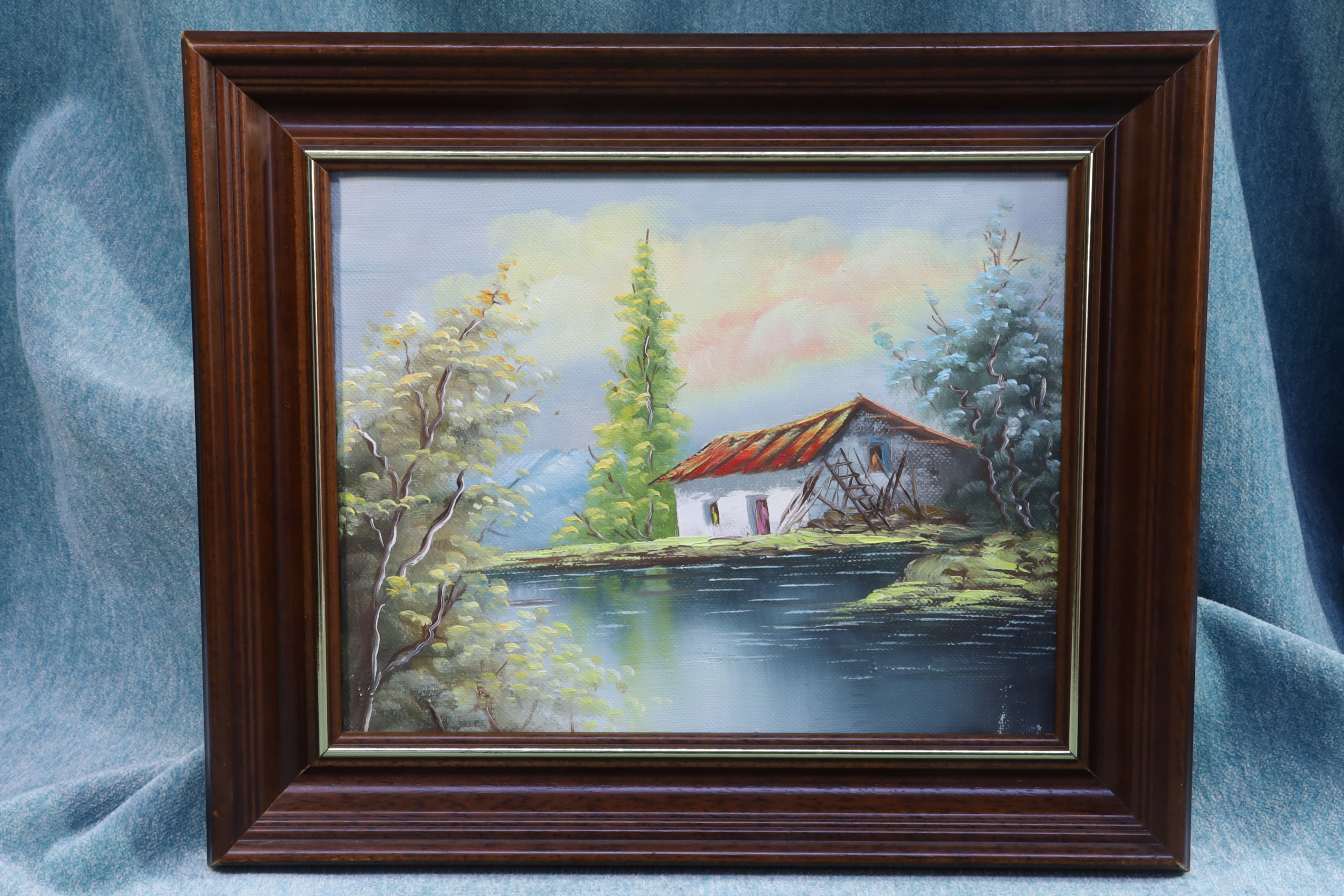 Antiguedades de oil on canvas of a country scene house by a river