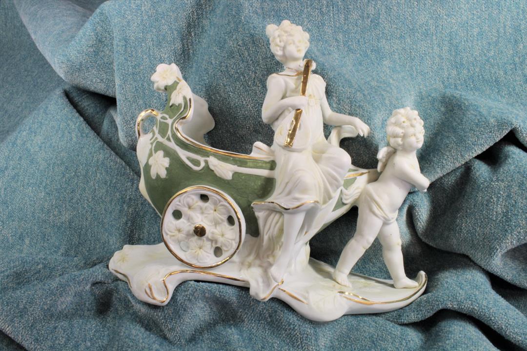 Antiques - BISCUIT VASE FIGURE. WOMAN WITH ANGEL AND SLEDGE. POLYCHROME. MODERNIST. (T)
